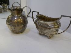 A silver two handled sugar bowl on four ball feet. Hallmarked Sheffield 1913 Sterwart Dawson and Co