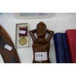 A pair of carved nut crackers in form of naked lady and an RSPCA medal