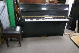 A modern Yamaha black lacquered Upright Piano, Model No. C110A (Serial No. C61954), with earlier sto
