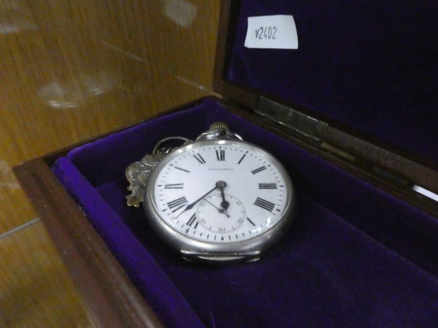 A silver cased Longines pocket watch, on a silver watch chain, and a vintage Accurist wristwatch