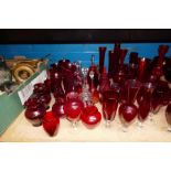 A quantity of red glass vases and similar