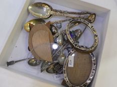 A quantity of spoons to include some silver, and some souvenir. Also with some silver oval photograp