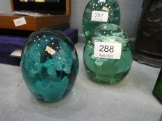 Two Victorian green glass dump paperweights