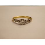 Antique 18ct and Platinum diamond ring with central round cut diamond and shoulders set with three s