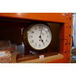 A ship's brass bulk head clock in later mahogany frame