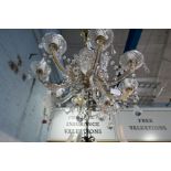 A vintage eight branch glass chandelier having pear shaped drops