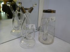 A very attractive twin oil and balsamic pourer. Glass on a raised circular base and silver covered t