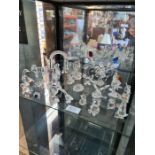 A shelf of Swarovski crystal figures, animals and similar