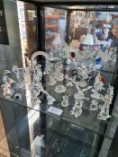 A shelf of Swarovski crystal figures, animals and similar