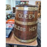An Oak and brass bound Brandy barrel with lid, with brass letters "The Queen God Bless Her"