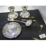 A pair of dwarf candlesticks by Williams (Birmingham) Ltd. Also, with a silver ashtray by Adie Broth