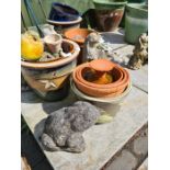 A selection of small glazed pots and reconstituted stone animal figures