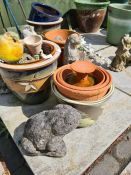 A selection of small glazed pots and reconstituted stone animal figures