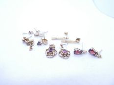 Collection of 9ct gold and yellow metal earrings to include garnets examples, contemporary drop eari