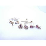 Collection of 9ct gold and yellow metal earrings to include garnets examples, contemporary drop eari