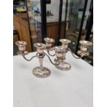 A pair of silver decorative candleabras having three branches, beaded borders, twisted arms and deco