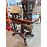 A Victorian Rosewood foldover card table on central pillar and spread base