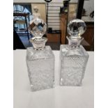 A pair of impressive cut glass decanters having silver collars. The glass has one small chip however