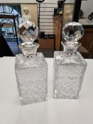 A pair of impressive cut glass decanters having silver collars. The glass has one small chip however