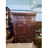 An old stained wooden cupboard having oak panelled door, the interior shelved