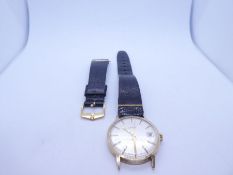 9ct gold cased Uno wristwatch with champagne dial, baton markers, date aperture on black leather str