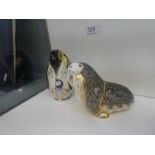 A Royal Crown Derby penguin paperweight and one other of Walrus both having gold button stamped 21,