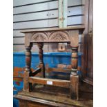A reproduction carved oak joint stool