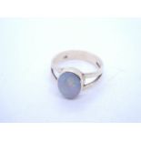 9ct yellow gold dress ring with split shoulders leading to oval cabouchon opal, rubover set, marked