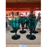 7 vintage green drinking glasses, three having engraved decoration