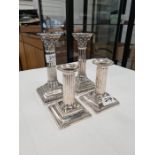 A pair of Hawksworth, Eyre and Co. Ltd. Silver candlesticks having gadrooned borders, embossed body