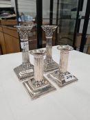 A pair of Hawksworth, Eyre and Co. Ltd. Silver candlesticks having gadrooned borders, embossed body