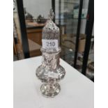 A very decorative Victorian silver caster with urn shaped body and gadrooned mounts. Heavily decorat