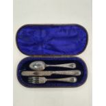 A cased Christening set of a knife, fork and spoon. Heavily decorated with engraved foliate scrolls