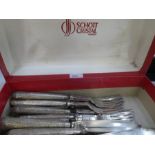 A quantity of knives and forks with very decorative white metal handles, potentially silver however