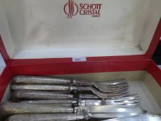 A quantity of knives and forks with very decorative white metal handles, potentially silver however