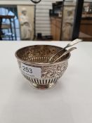 A very decorative Victorian silver sugar bowl having half reeded body with embossed foliate design a