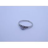 Platinum diamond ring with central brilliant round cut diamond, approx 0.25 carat with graduating di