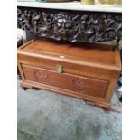 A modern Chinese hardwood blanket box having carved front