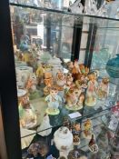 A shelf of Beatrix Potter figures, mainly Royal Albert and other related items