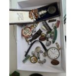 A collection of vintage railway items including enamel badges, a pocket watch (ticking away nicely),