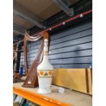 A harp style instrument, one other string instrument and a lamp