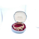 Very pretty 1960s 14ct yellow gold hinged bangle decorated lily pads, pearls and garnets, internal w