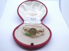 Omega; 18ct yellow gold cased Omega quartz wristwatch with oval diamond set bezel, on pretty ropetwi