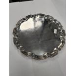 A silver tray of circular form having decorative raised border. Hallmarked Birmingham 1935 Cohen and