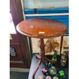 An antique mahogany tilt top tripod table