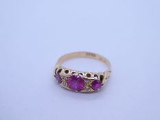 18ct yellow gold ruby and diamond ring with 3 graduating round cut rubies spaced with 4 small diamon