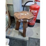 A rustic style milking stool by George Walker and an old ship awning handle