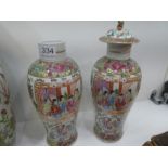 A pair of 19th Century Chinese Canton vases decorated panels of figures (one with lid), and a larger