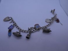 Vintage Silver charm bracelet hung 8 charms to include tankard, souvenir plaques, boat lamp, etc and