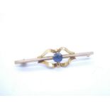 Yellow gold decorative bar brooch set with blue paste stone, marks worn, approx 1.4g